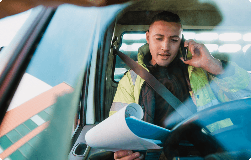 Man looking at paperwork while sitting in his van