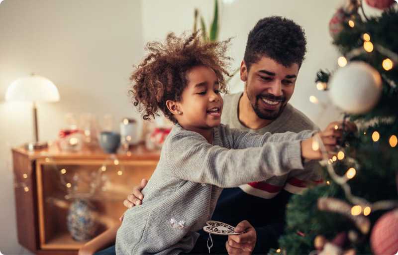 Father with son decorating a christmas tree