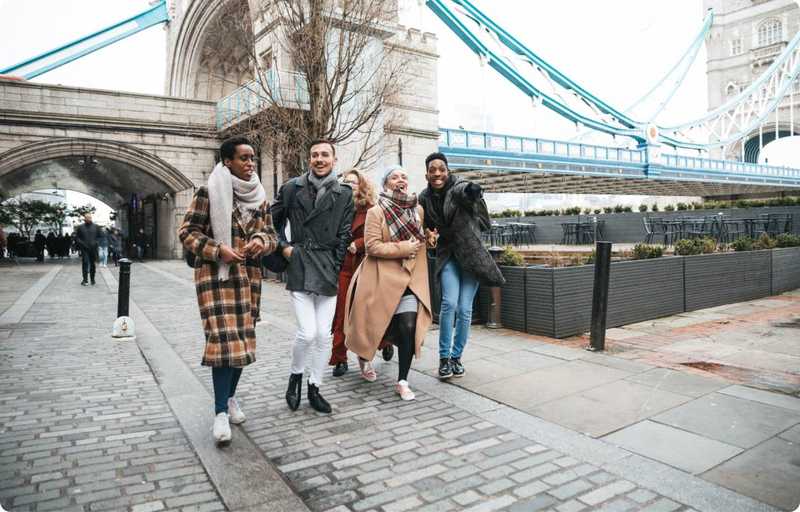 Friends walking under bridge